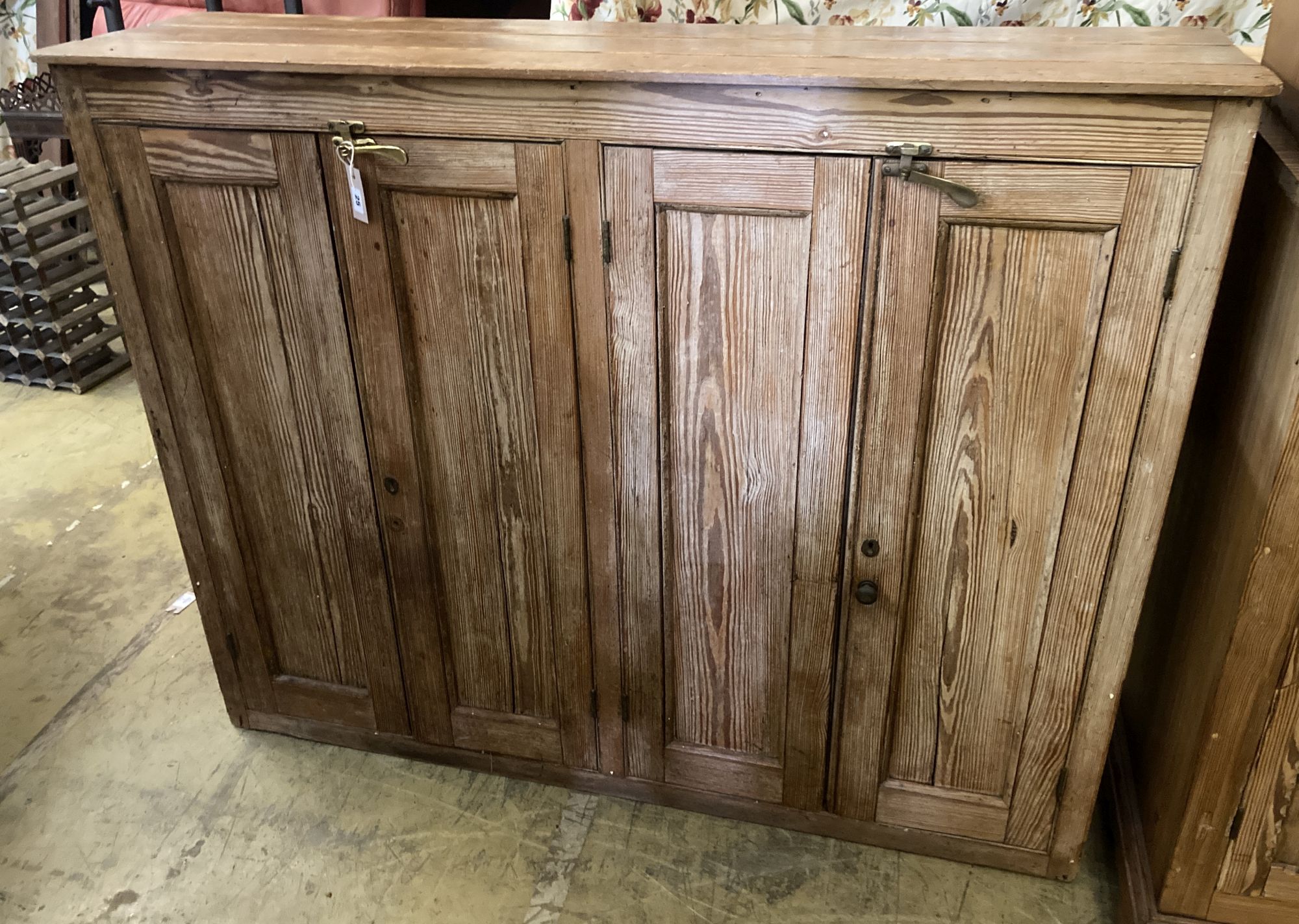 A Victorian pitch pine four door cabinet, width 146cm, depth 38cm, height 116cm